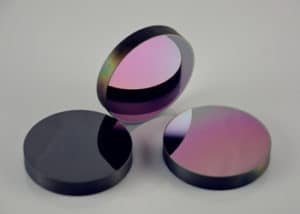 Germanium (Ge) windows are available off-the-shelf with three anti-reflection coating options: 3 – 5μm for mid-infrared applications, 3 – 12μm for broadband multispectral applications, or 8 – 12μm for thermal imaging applications. Due to its high index of refraction (around 4.0 from 2 – 14μm), an anti-reflection coating is recommended on these germanium windows for sufficient transmission in the region of interest. Germanium is subject to thermal runaway, meaning that the transmission decreases as temperature increases. As such, these germanium windows should be used at temperatures below 100°C. Germanium’s high density (5.33 g/cm3) should be considered when designing for weight-sensitive systems. The Knoop Hardness of germanium (780) is approximately twice that of magnesium fluoride, making it ideal for infrared applications requiring rugged optics.